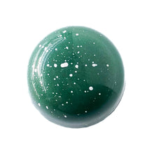 Green and white Chocolate bonbon.  Utah honey caramel with pistachio gianduja.  The Chocolate Palette Salt Lake City Utah